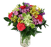 Enjoy the day with a wonderful arrangement of yellow daisies, green mums, mauve daisies with fuchsia carnations.