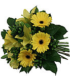 All yellow hand tied floral bouquet of lilies and Gerbera daisies with hypericum berries and greens.
