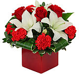 A stylish red cubed vase is arranged with romantic red and white flowers perfect for Anniversary gift giving.