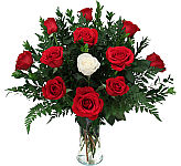 Our Special Love Arrangement features 11 red roses surrounding a single, beautiful white rose. Beautiful flowers combined with same day service.