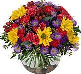Glass bowl of bright, bold and colourful flowers arranged for any occasion. Bowl includes decorated rocks on the bottom.