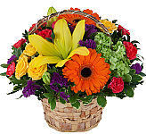 Colourful assortment of popular flowers arranged in a natural woven handled basket for any occasion or sentiment.