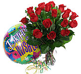 Eighteen red roses are arranged in a clear glass vase with a festive birthday balloon. We are Canada Flowers, Canada's national florist.