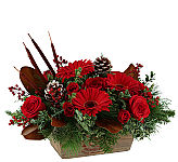 An original design featuring a dark wicker basket filled with crimson shades of red gerberas and much more.