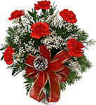 Vase arrangement of six red Christmas carnations with baby's breath, seasonal greens, red bow and pine cone for holiday delivery across Canada.