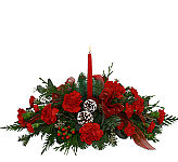 Classic Centerpiece arrangement with hurricane lamp, featuring red carnations and miniature carnations, Christmas greenery and trim.
