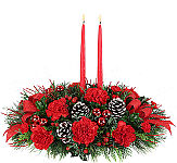 All red Up on the Rooftop Centerpiece with two red taper Candles, red glass balls, frosted pine cones and more by Canada Flowers. Same day Christmas flower delivery across Canada.