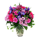 Pretty floral arrangement in a vase featuring pink daisies, pink Gerbera daisies and much more for Admin Prof Day.