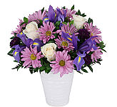White ceramic vase arrangement with white roses, mauve daisies, dark purple mums and purple iris