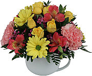 A delightful arrangement in a coffee mug that is sure to bring a smile to their face during the Easter season. Available for same day delivery across Canada.