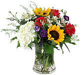 Sunflowers, hydrangea, roses, and alstroemeria arranged in a vase.