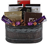 Assorted chocolates, truffles, chocolate bars and boxes of mixed chocolates arranged in a handsome metal container for Father's Day.
