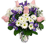 Six pink roses are arranged with white daisies and purple irises. We call this arrangement, Excitement! Same day flower delivery across Canada.