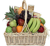 Abundant assorted fruit in a handled wicker basket with added cheeses and crackers. A tantalizing selection for the tastebuds.