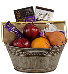 Essentials is an easy to give gift of assorted fresh fruit with chocolate bars, including dark chocolates.