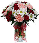 A clear glass cylinder vase is arranged with white daisies, pink carnations, and beautiful red spray roses. Makes a nice gift for sending your get well wishes.