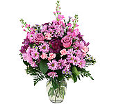 Pretty arrangement in a vase of pink, purple, mauve and lavender blooms. Same day flower delivery across Canada.