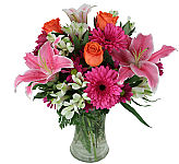 Fresh! A new arrangement of beautiful, uplifting blooms arranged in a clear glass vase. Featuring lilies, roses, Gerbera daisies and more. Freshest blooms combined with outstanding style and grace.