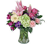 Pretty floral arrangement in a vase featuring stargazer lilies, yellow Gerbera daisies and much more for Mother's Day.