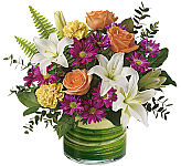 ​Spread sunshine and smiles with this bright yellow and bold purple bouquet, beautifully presented in a shimmering, iridescent aqua vase they'll enjoy for years to come!