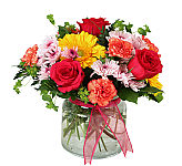 Pretty glass vase floral arrangement of peach, pink, yellow and mauve flowers for birthdays or anytime giving.