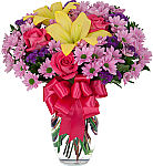 Vase arrangement of beautiful pink roses, lavender daisies, purple statice and yellow lilies with matching silky bow.