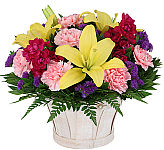 Send thanks with a cheerful basket arrangement of yellow lilies and more.