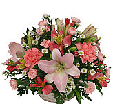 Send a basket of pink flowers arranged in a handled whitwash basket. Same day delivery across Canada with Canada Flowers.