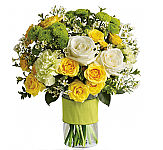 This dazzling bouquet includes white roses, yellow spray roses, green carnations, green button spray chrysanthemums and white waxflower accented with assorted greenery. Delivered in a glass cylinder vase.
