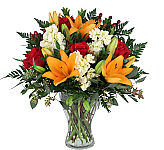 Vase arrangement of orange lilies, white stock, red roses, hypericum berries, seeded euc and greens.