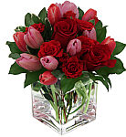 Canada Flowers presents a fresh new arrangement of red roses with red and pink tulips in a clear glass cube vase for Valentine's Day. Featuring same day florist delivered flowers across Canada.