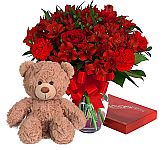 A gorgeous all red flower arrangement plus box of chocolates and plush teddy bear for Valentine's Day.