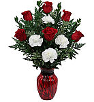A red glass vase is arranged with red roses and white carnations, accented with assorted greenery. Same day delivery across Canada.