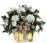 White flowers arranged in a basket for the holidays with gold leaves, gold balls, gold pine cones and gold bow.