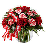 The FTD® Winter Elegance Bouquet is a pretty presentation of red roses and variegated candy cane carnations with a seasonal greens and cheerful bow.