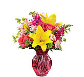 FTD® 17-M1 Pink glass vase arrangement to include pink roses, pink alstromeria, yellow lilies, purple snapdragons, bumplerum and greens.