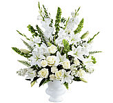 Traditional all white sympathy arrangement for the funeral home, featuring roses, lilies, gladiolus, carnations and stock.