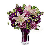 FTD® V22 Purple glass vase arrangement of lavender roses, pink Hybrid Lilies, fragrant purple gillyflowers, purple Matsumoto asters and Queen Anne's Lace accent