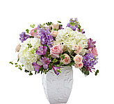 Send your condolences with a stunning arrangement that includes hydrangea, spray roses and stock. Each gorgeous flower in our FTD Peace and Hope™ Lavender Bouquet is complimented by an elegant dove and leaf-patterned vase to lift them up. 