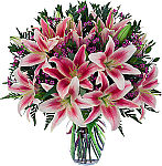 Beautiful vase arrangement of several stargazer lilies with foliage accents and delicate complementary pink flowers. Sympathy and funeral flowers by Canada Flowers.