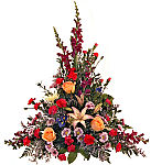 Budget funeral flowers for the funeral home from Canada Flowers. Traditional onesided funeral arrangement of snapdragons, roses, daisies, carnations, lilies and blue iris.