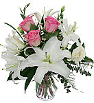 Affordable funeral flower arrangement of pink roses with white lilies and complementary white blooms. Flowers delivered across Canada.