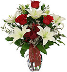 Affordable flowers for the funeral home, featuring a glass vase arranged with white lilies, red roses and limonium. Same day delivery across Canada.
