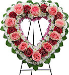 Cherished is an open heart shaped funeral wreath made with layers of roses, carnations, mums and salal.