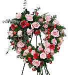 Treasured Memories is a beautiful heartshaped funeral wreath with pink roses, spray roses, Gerbera daisies and assorted green foliage. Available for delivery across Canada.