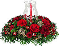 Premium holiday floral centerpiece with single red candle in a glass hurricane globe lamp.