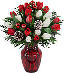 A red holiday vase holds 20 or more red and white tulips plus red ornamental balls, frosted pinecones and cedar greens.