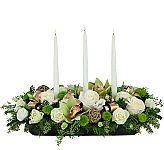 Premium flower centerpiece for the holidays, featuring white roses, green cymbidium orchids and 3 white taper candles.
