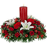Beautiful and luxurious red and white Christmas floral centerpiece with red pillar candle.