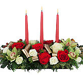 Premium floral centerpiece for the holidays, featuring red and white roses, cymbidium orchids and candles.
